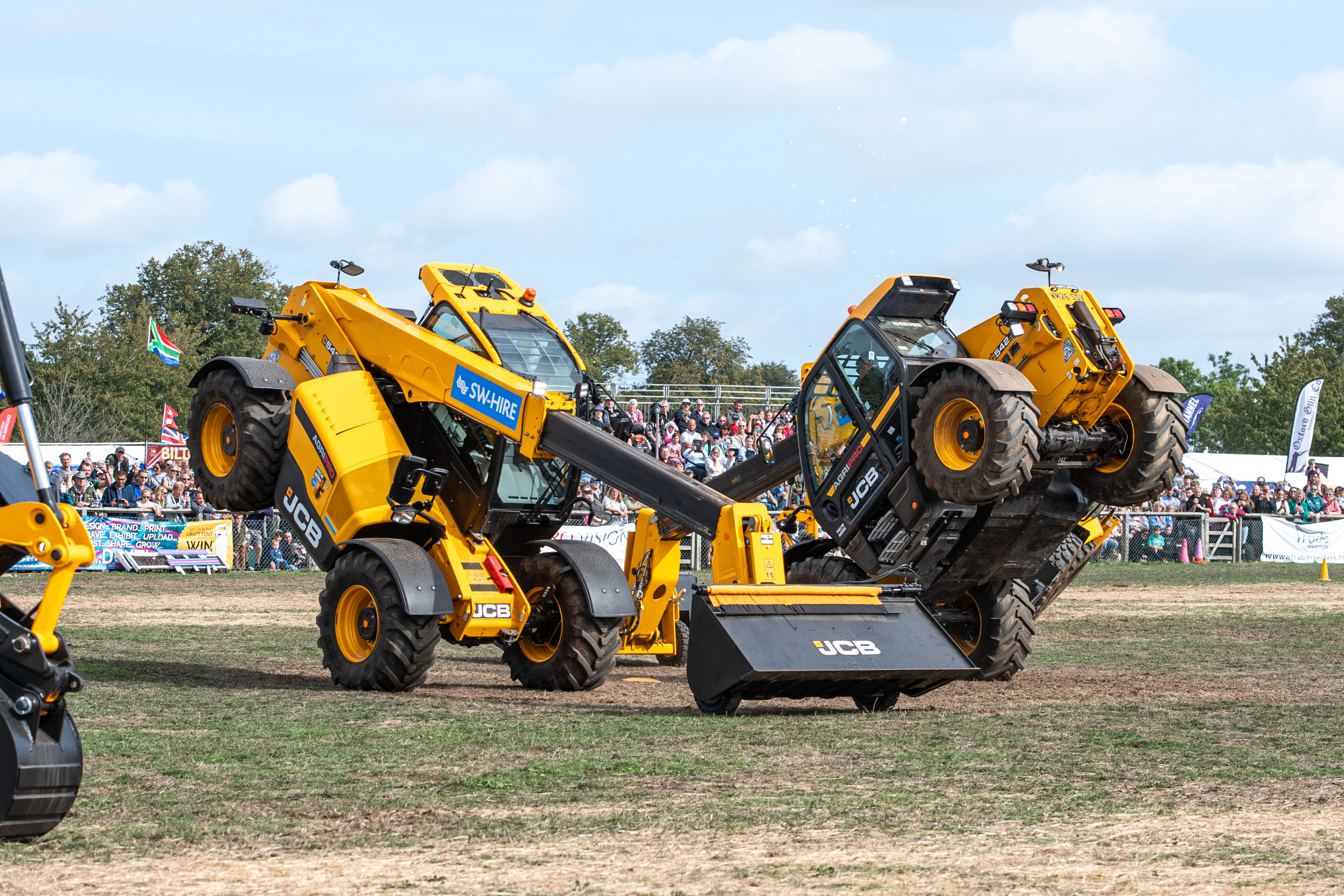 JCB 542-70 AgriPro telehandlers balanced on their front axle's as part of JCB Dancing Digger Display